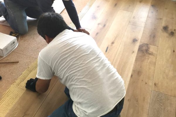 13c AMRON workers installing oak engineered floor
